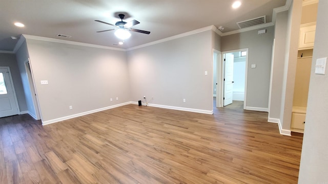 spare room with light hardwood / wood-style floors, ceiling fan, and crown molding