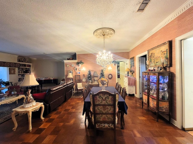 dining area featuring dark parquet floors, a textured ceiling, and an inviting chandelier