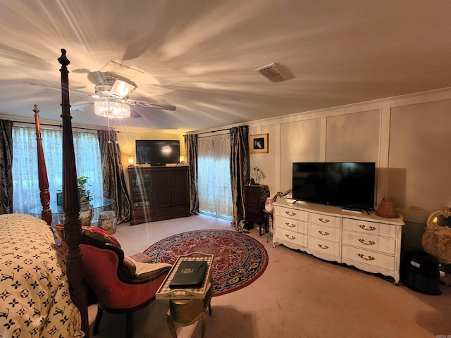 bedroom with ceiling fan, light colored carpet, and ornamental molding