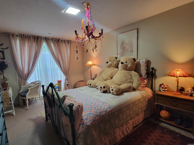 carpeted bedroom featuring a textured ceiling and a notable chandelier