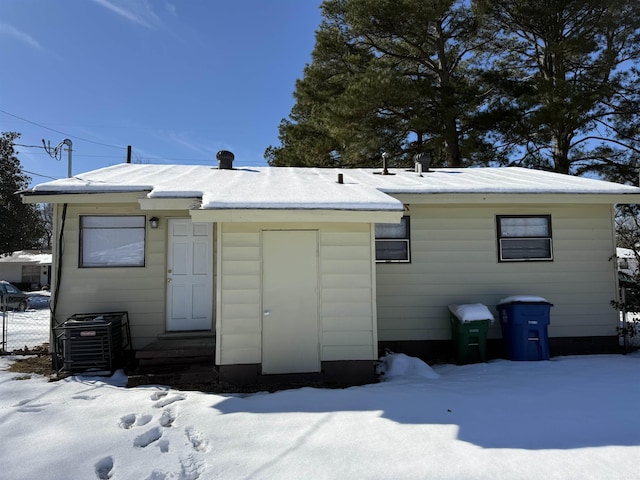 view of snow covered back of property