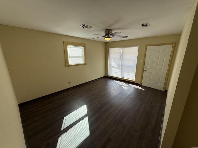 spare room with ceiling fan and dark hardwood / wood-style floors