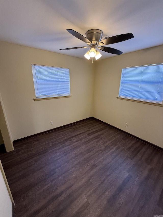 unfurnished room with dark hardwood / wood-style floors and ceiling fan