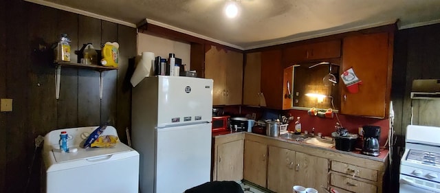 kitchen featuring white appliances, sink, and washer / clothes dryer