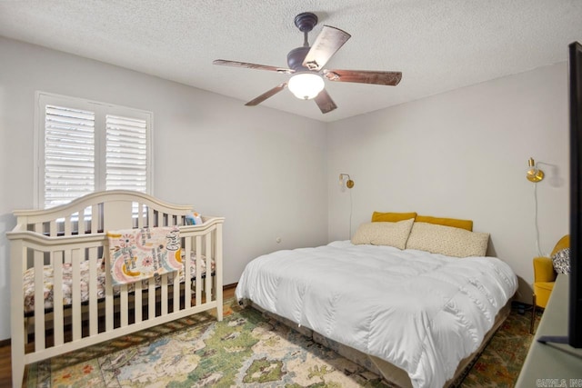 bedroom with a textured ceiling and ceiling fan