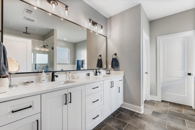 bathroom featuring vanity and a shower with shower door