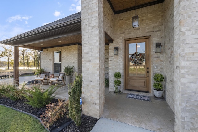 view of exterior entry with covered porch