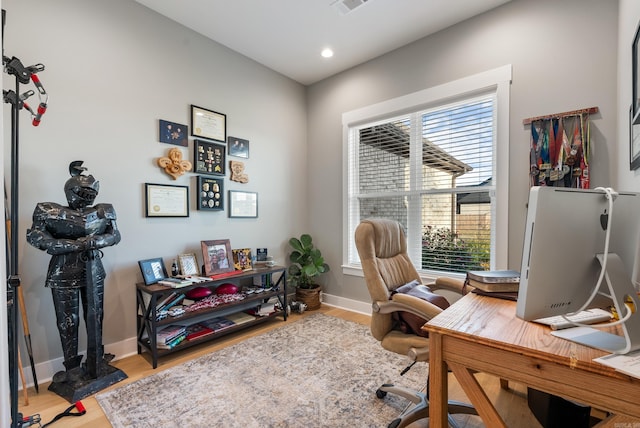 office space featuring plenty of natural light and wood-type flooring