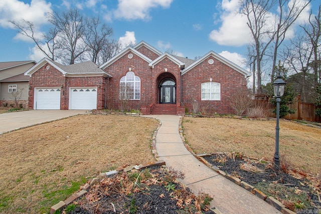 view of front of home with a front yard and a garage