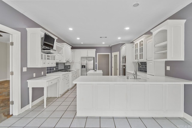 kitchen featuring white cabinets, kitchen peninsula, stainless steel appliances, and light tile patterned floors