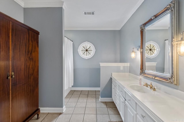 bathroom featuring tile patterned flooring, vanity, and crown molding