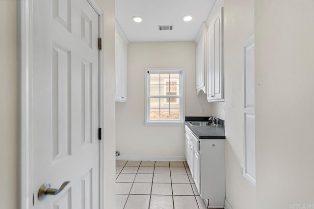 laundry room featuring light tile patterned flooring and sink