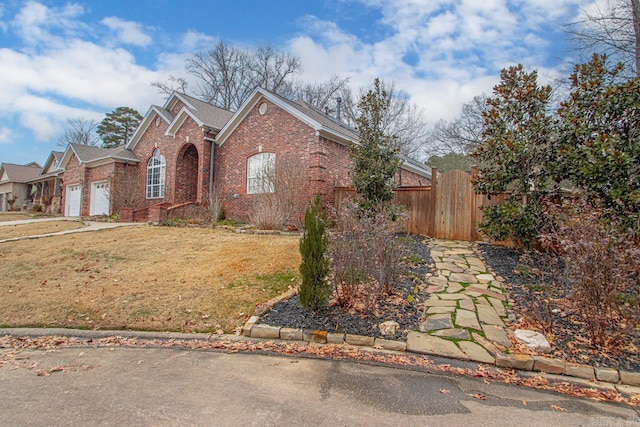 view of front property featuring a garage and a front lawn