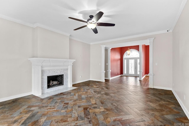 unfurnished living room with ceiling fan, ornamental molding, a premium fireplace, and dark parquet floors