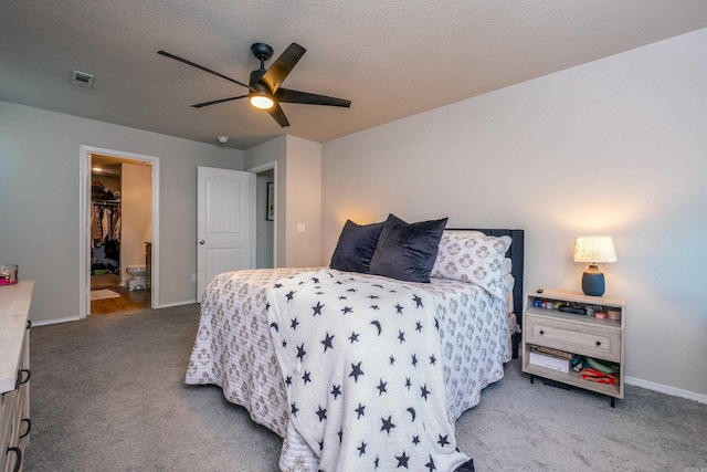 carpeted bedroom with ceiling fan and a textured ceiling