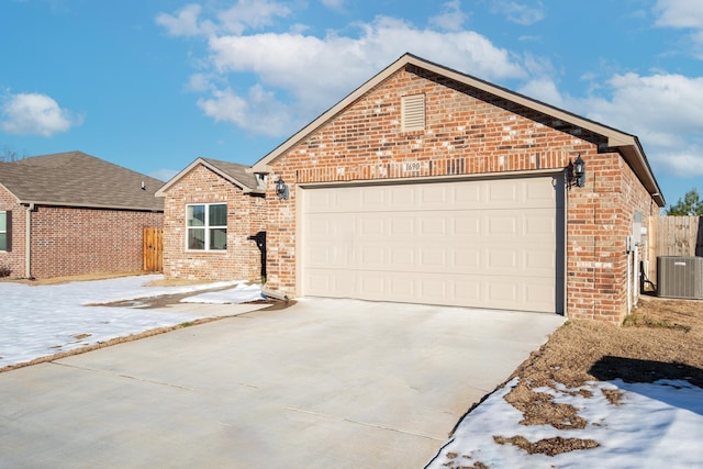 front of property featuring central AC and a garage