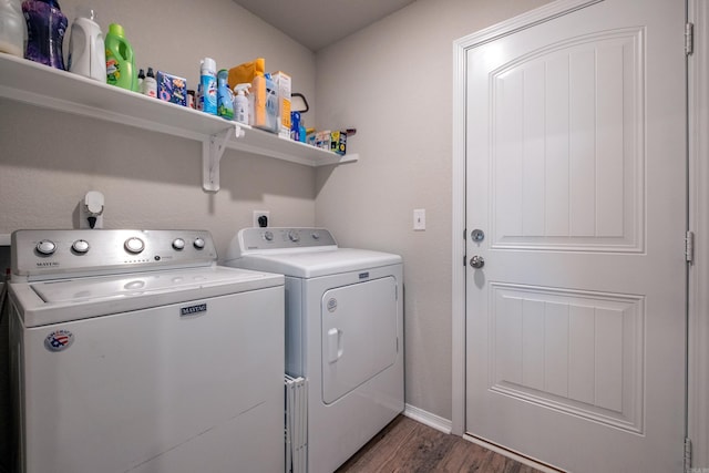 laundry area with dark hardwood / wood-style flooring and washing machine and dryer