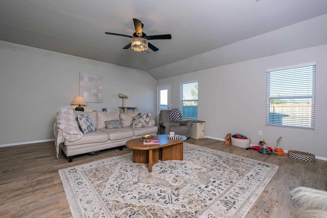 living room featuring a textured ceiling, ceiling fan, lofted ceiling, and hardwood / wood-style flooring