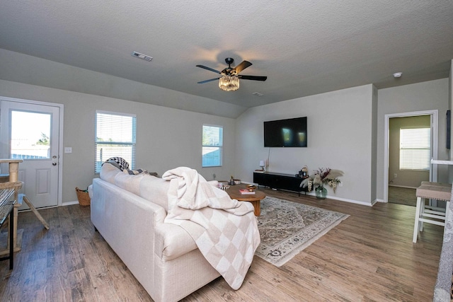 living room featuring hardwood / wood-style floors, ceiling fan, and a healthy amount of sunlight