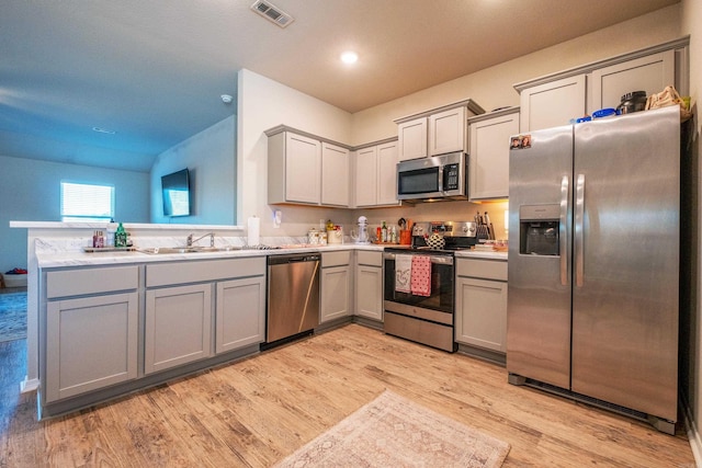 kitchen featuring gray cabinets, sink, and appliances with stainless steel finishes