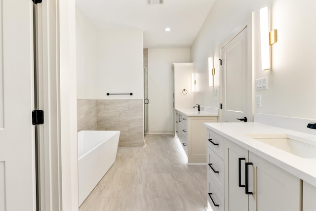 bathroom with separate shower and tub and vanity