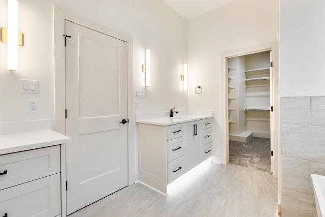 bathroom with vanity and tile walls