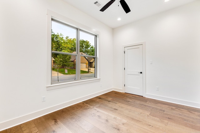 spare room with ceiling fan and light wood-type flooring