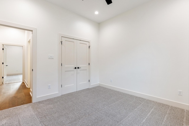 empty room with ceiling fan and carpet floors