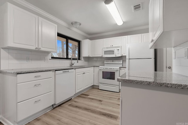 kitchen featuring light stone counters, white appliances, crown molding, sink, and white cabinets