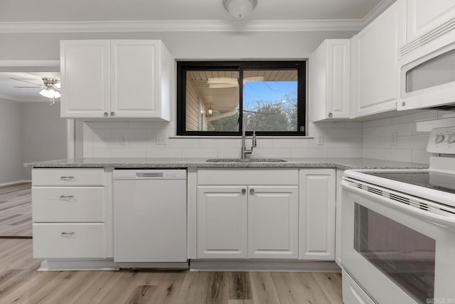 kitchen featuring white appliances, white cabinets, sink, ceiling fan, and stone countertops