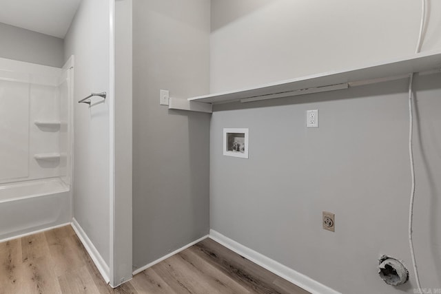 laundry room featuring washer hookup and light hardwood / wood-style floors