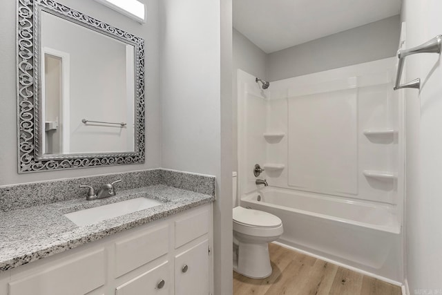 full bathroom featuring wood-type flooring, vanity, toilet, and shower / bathtub combination