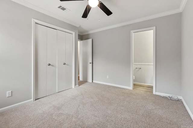 unfurnished bedroom featuring ceiling fan, light colored carpet, and crown molding