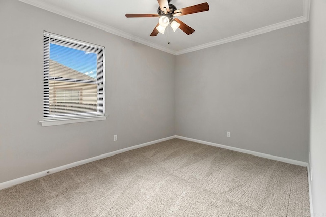 carpeted spare room featuring crown molding and ceiling fan