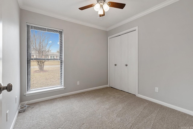 unfurnished bedroom featuring carpet, multiple windows, a closet, and ceiling fan