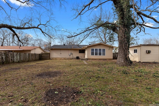 rear view of property with a lawn