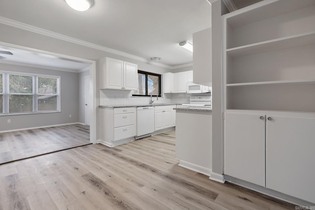 kitchen with decorative backsplash, white cabinets, a healthy amount of sunlight, and white appliances