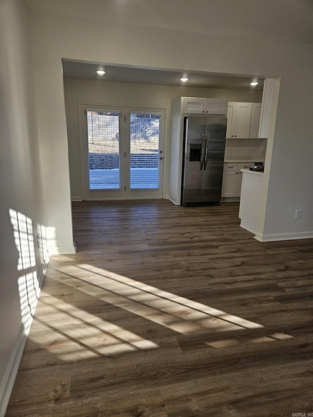 kitchen featuring stainless steel fridge with ice dispenser, dark hardwood / wood-style flooring, and white cabinets