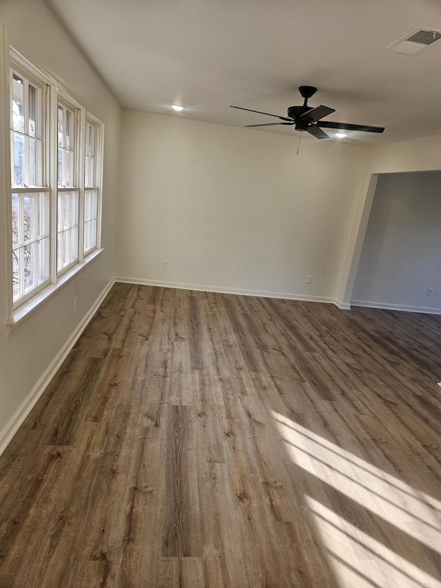 spare room featuring dark hardwood / wood-style floors and ceiling fan