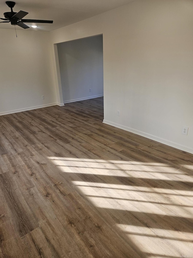 empty room featuring ceiling fan and wood-type flooring