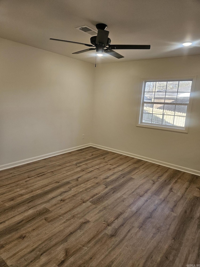 empty room featuring ceiling fan and dark wood-type flooring