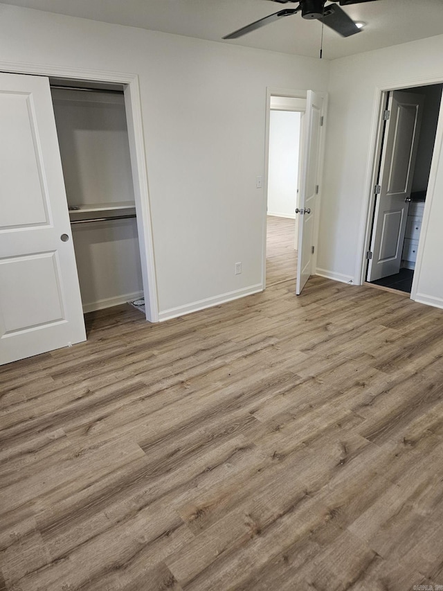 unfurnished bedroom featuring ceiling fan, light wood-type flooring, and a closet