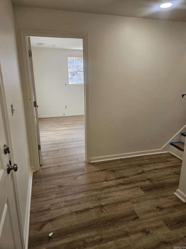 corridor featuring dark wood-type flooring