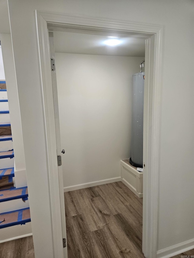 bathroom featuring wood-type flooring and water heater