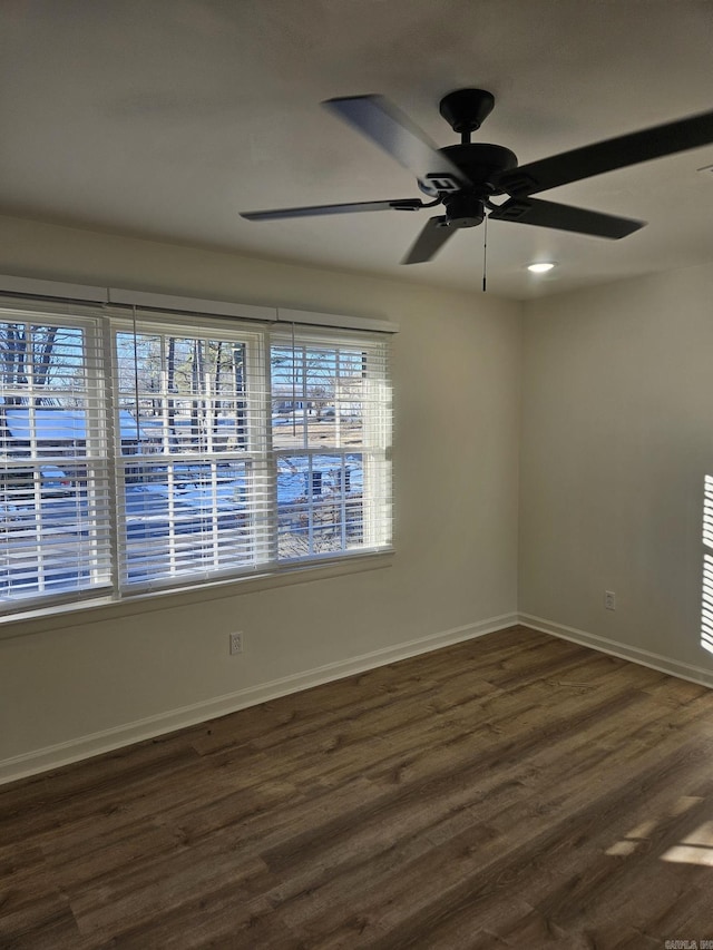 empty room featuring dark hardwood / wood-style floors and ceiling fan