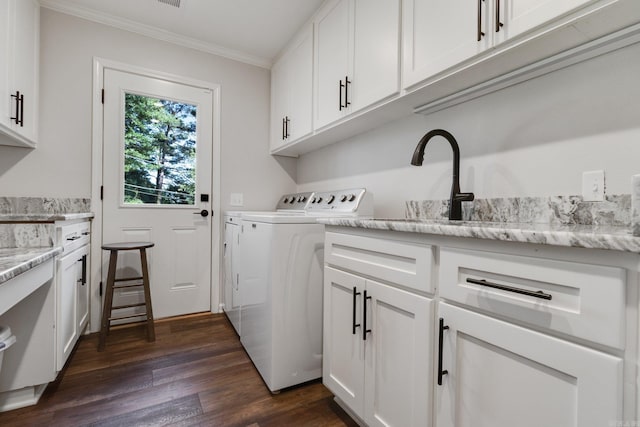 clothes washing area with sink, cabinets, separate washer and dryer, dark hardwood / wood-style floors, and crown molding