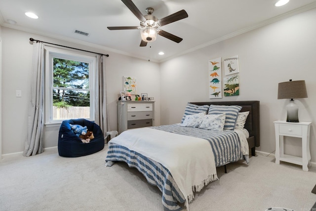 carpeted bedroom featuring ceiling fan and crown molding