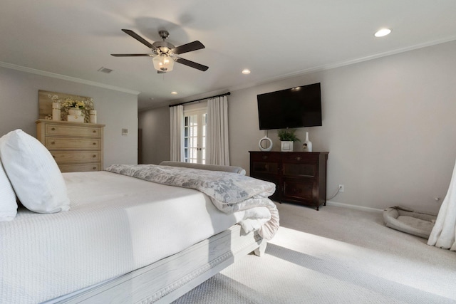 carpeted bedroom featuring ceiling fan and crown molding