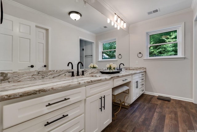 bathroom featuring hardwood / wood-style floors, vanity, and crown molding