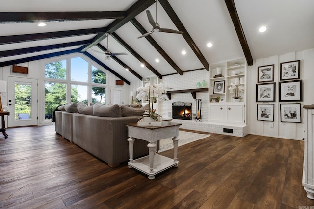 living room with beam ceiling, ceiling fan, high vaulted ceiling, dark hardwood / wood-style floors, and a fireplace